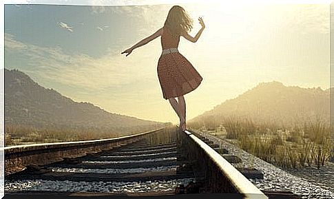 Woman walks on train track