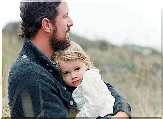 Father holding daughter