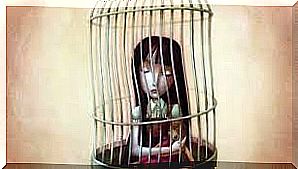 Girl sitting in cage as a symbol for the prison of emotion eating.