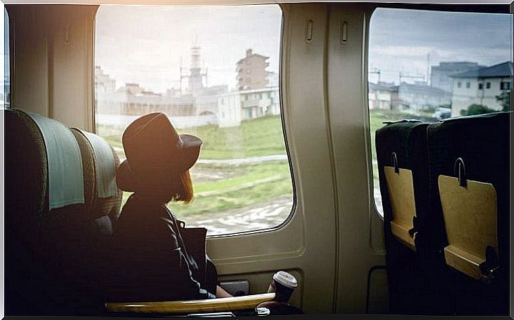 Girl sitting on the train looking out the window and thinking about breaking up