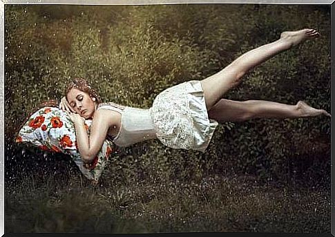 Woman sleeps in a meadow