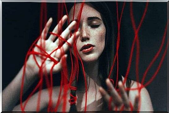 A girl tangled in red threads