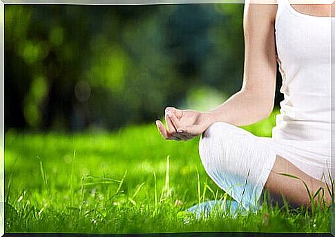 Woman meditating in the grass