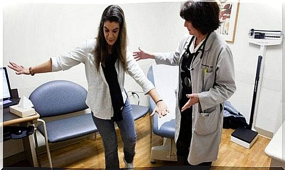 Doctor helps patient with multiple sclerosis to walk