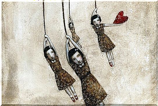 Four girls holding on to a rope and one is holding a heart too