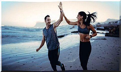 Two people running on the beach