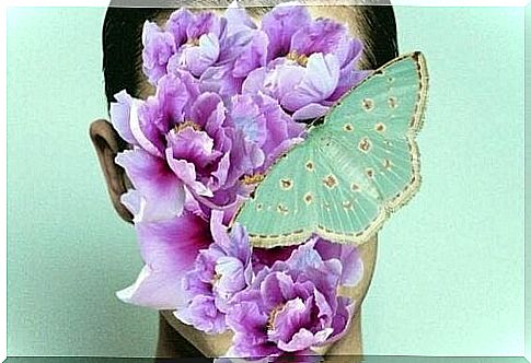 Woman whose face is covered with purple flowers and a blue butterfly