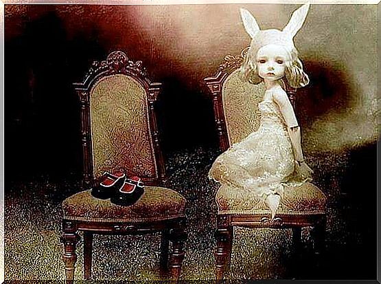 Bunny-eared girl sitting on a chair next to a chair with her shoes on