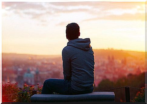 Boy looking over the city and thinking about the secret of happiness